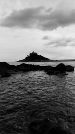 Scenic view of sea against cloudy sky