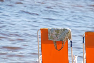 Close-up of metal railing against sea