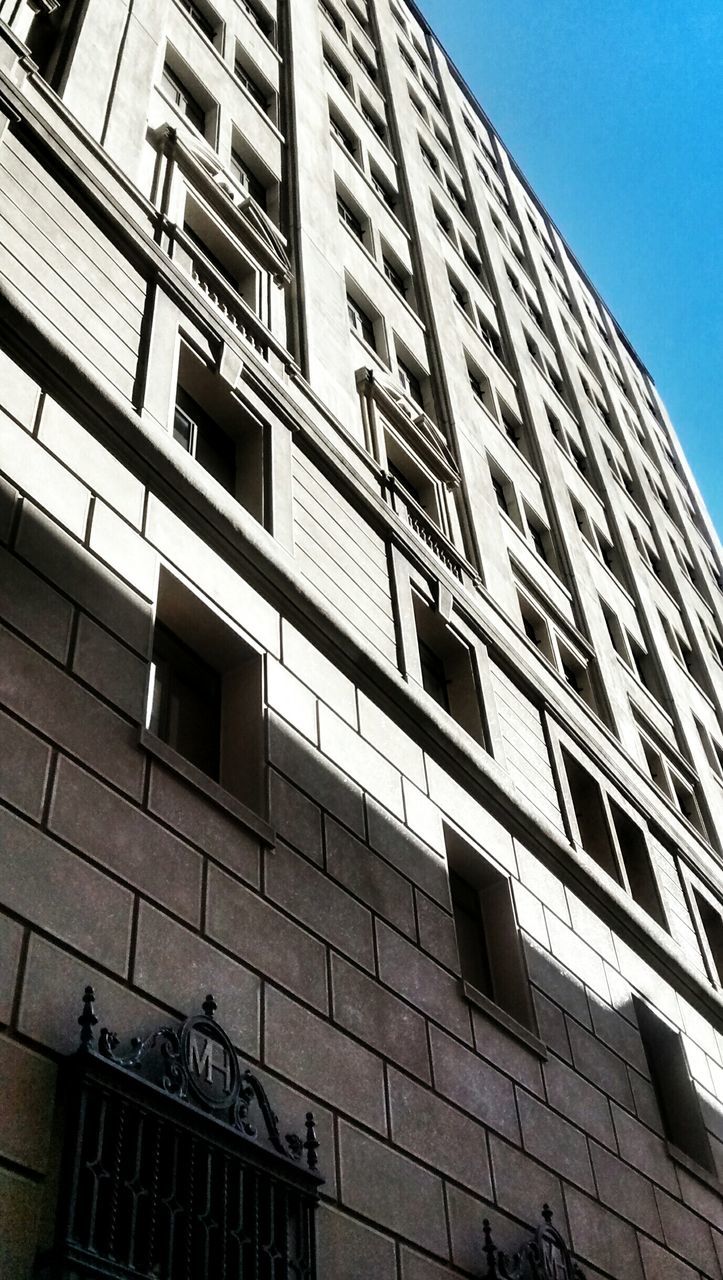 architecture, building exterior, built structure, low angle view, window, building, city, modern, office building, glass - material, residential building, residential structure, day, clear sky, reflection, brick wall, outdoors, no people, apartment, sky