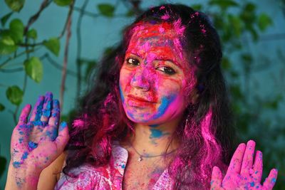 Young girl celebrating festival of colours holi. 