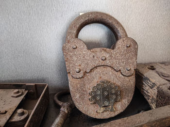 Close-up of rusty padlock on wall