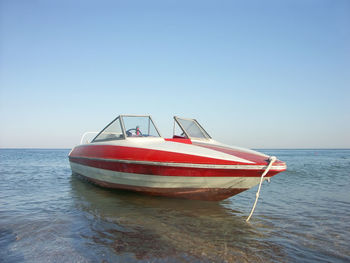 Motorboat made fast nearshore against clear blue sky