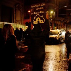 Rear view of people standing on road at night