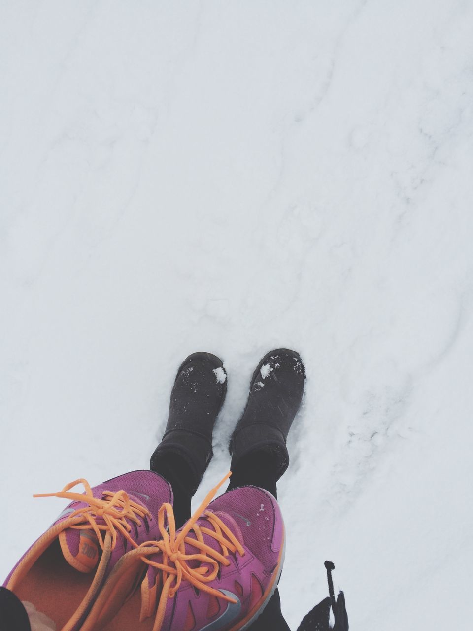 lifestyles, low section, leisure activity, person, shoe, personal perspective, standing, men, high angle view, footwear, unrecognizable person, human foot, casual clothing, day, snow, outdoors