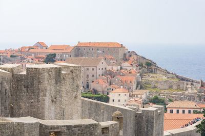 View of town by sea against sky