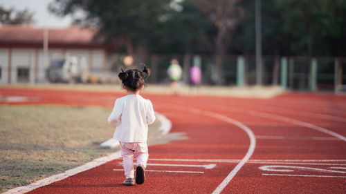 Rear view of woman running outdoors