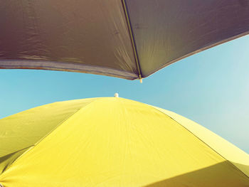 Low angle view of yellow tent against sky