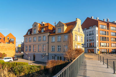 Buildings in city against clear blue sky