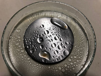 High angle view of wet coffee in container