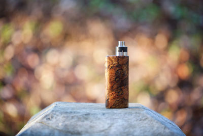 Close-up of cigarette on wooden post