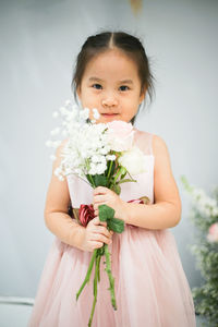 Portrait of a girl holding flower bouquet