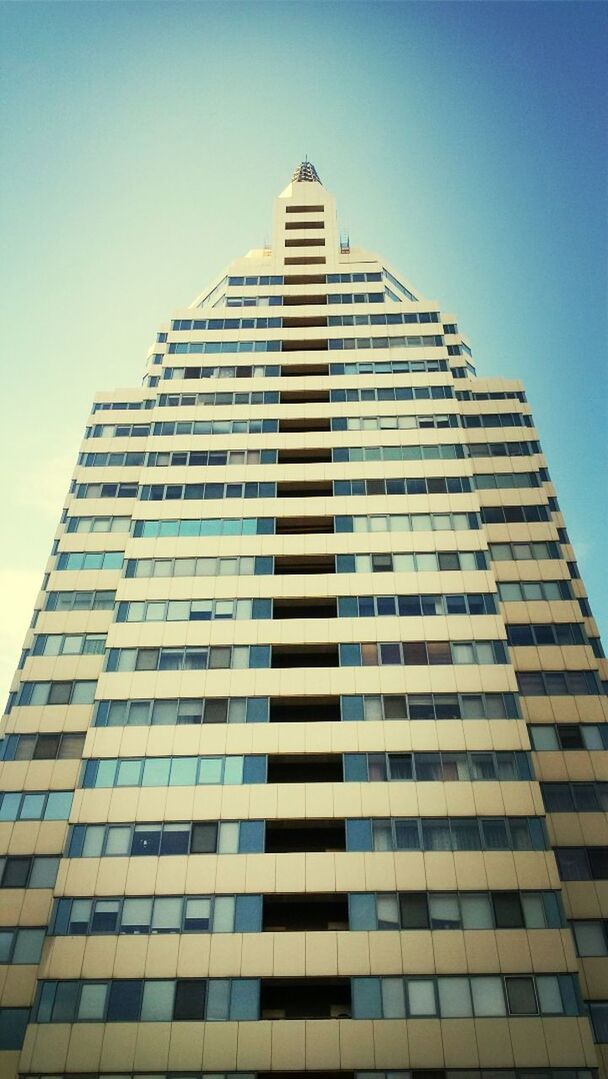 building exterior, architecture, built structure, low angle view, clear sky, modern, office building, tall - high, skyscraper, city, tower, building, blue, tall, glass - material, day, outdoors, sky, no people, window