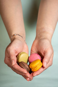Close-up of woman holding macarons