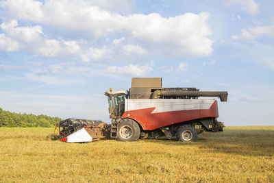 Old combine harvester harvests. agricultural combine on the field