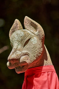 Close-up of person holding animal sculpture