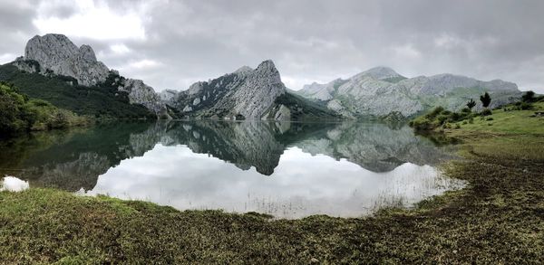 Scenic view of lake and mountains against sky