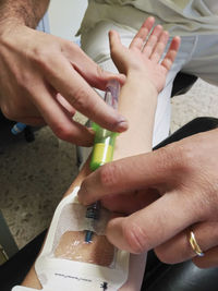 Cropped image of doctor preparing patient for blood donation