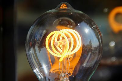 Close-up of illuminated light bulb