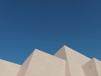 Low angle view of building against clear blue sky