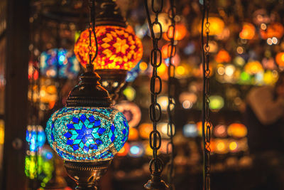 Close-up of illuminated decorative lanterns hanging in shop