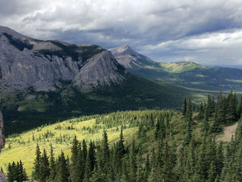 Scenic view of mountains against cloudy sky