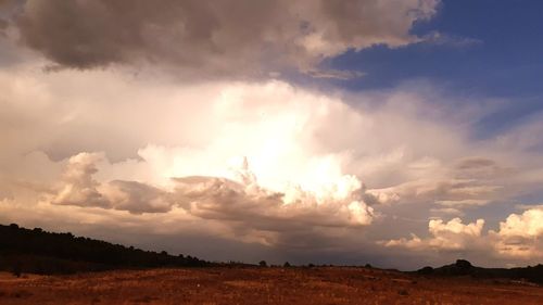 Scenic view of field against sky during sunset