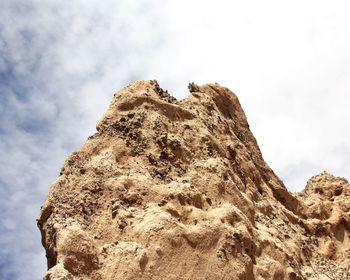 Low angle view of rock formation against sky