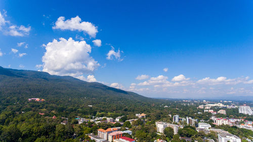 View of cityscape against cloudy sky