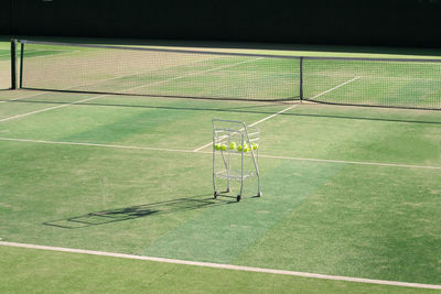 High angle view of tennis balls in trolley on court