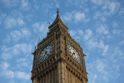 Low angle view of clock tower against sky