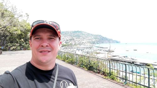 Portrait of boy standing in sea against clear sky