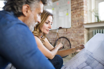 Team of architects discussing the rebuilding of a loft office