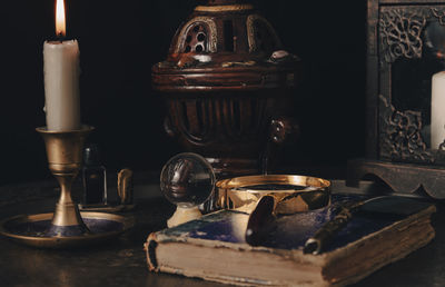 Close-up of burning candles on table