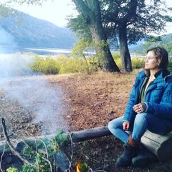 Full length of woman sitting on land