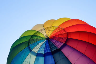 Low angle view of hot air balloon against clear blue sky