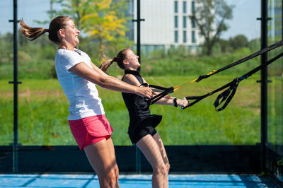 Full length of woman with arms raised