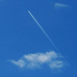 Low angle view of vapor trail in blue sky