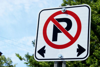 Low angle view of road sign against sky