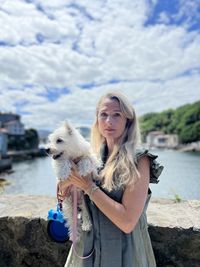 Portrait of woman with dog on beach