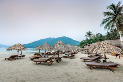 Panoramic view of people on beach against clear sky