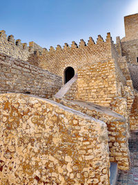 Low angle view of old ruins against sky