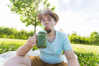 Full length of young man sitting in park