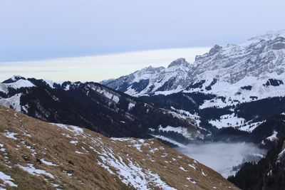 Scenic view of snowcapped mountains against sky