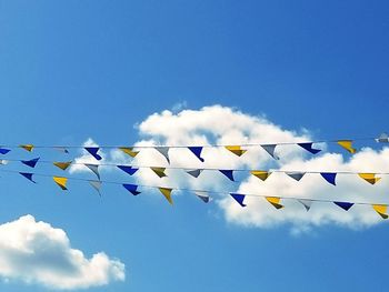 Low angle view of flags against sky