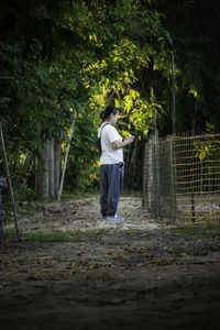 Rear view of woman walking in forest