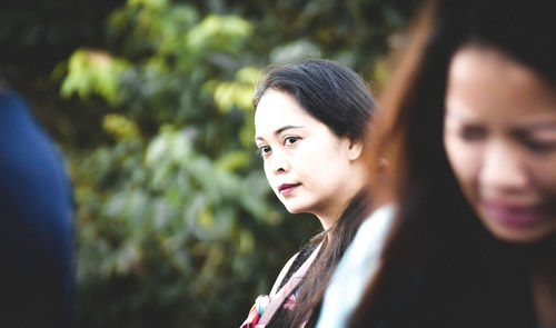 Portrait of a young woman looking away