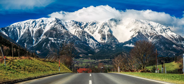 Road amidst mountains against sky