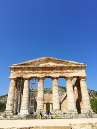 Low angle view of old temple against clear blue sky