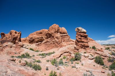 Low angle view of rock formation against blue sky at arches national park