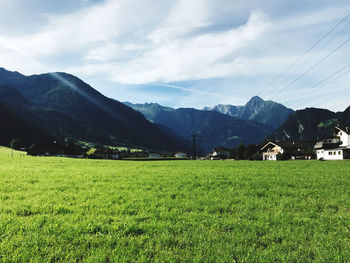 Scenic view of field and mountains against sky